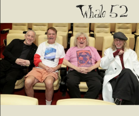 2026-06-06_12-48-22 - We Got Bruce! Four men sit in beige theater seats smiling for a photo, with a ‘Whole 52’ logo visible at the top.